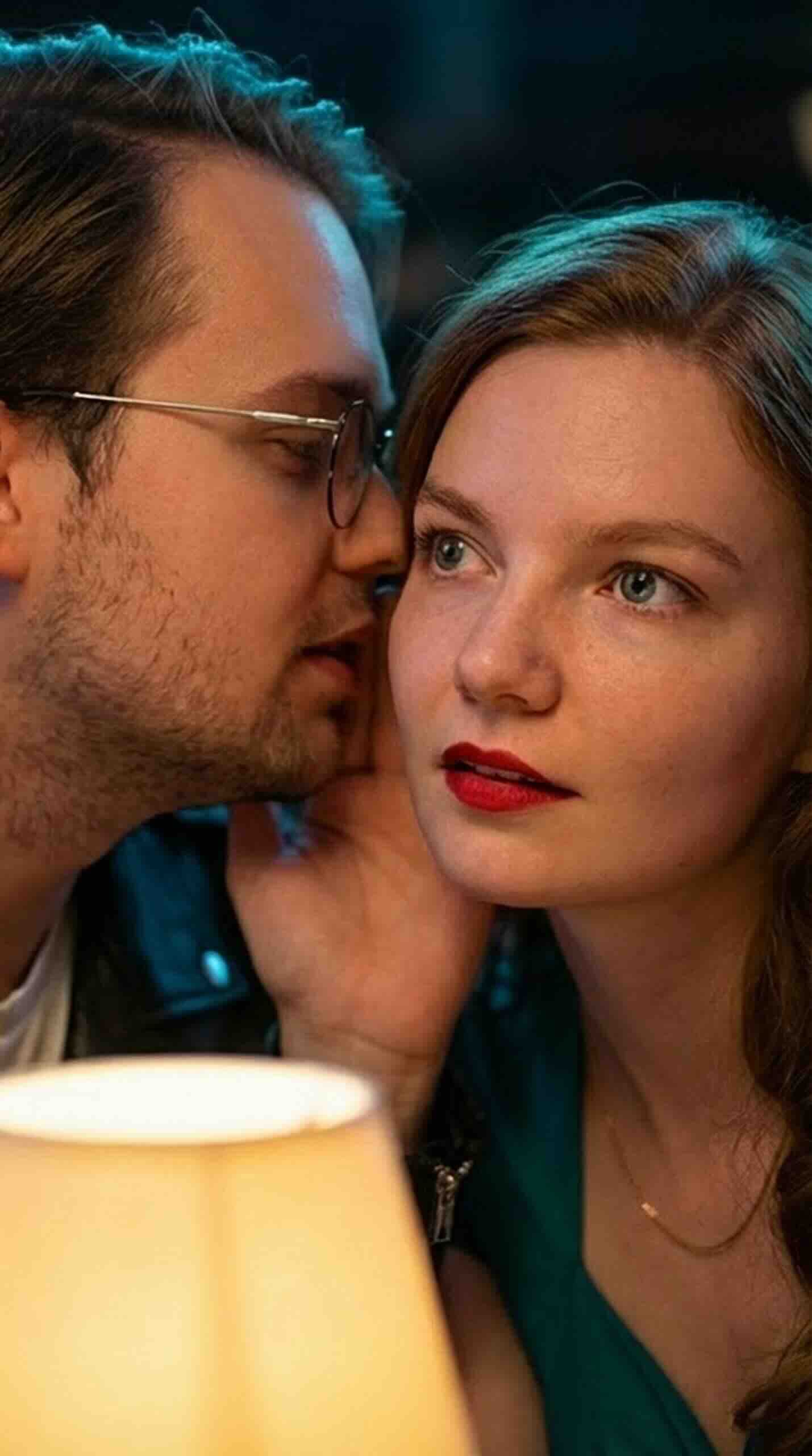 Cinematic couple photos: guy in leather jacket and girl in diner at night.