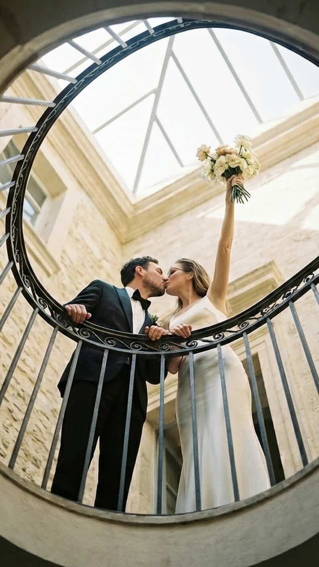 married couple photography: couple against stone wall, sunlight, clean lines