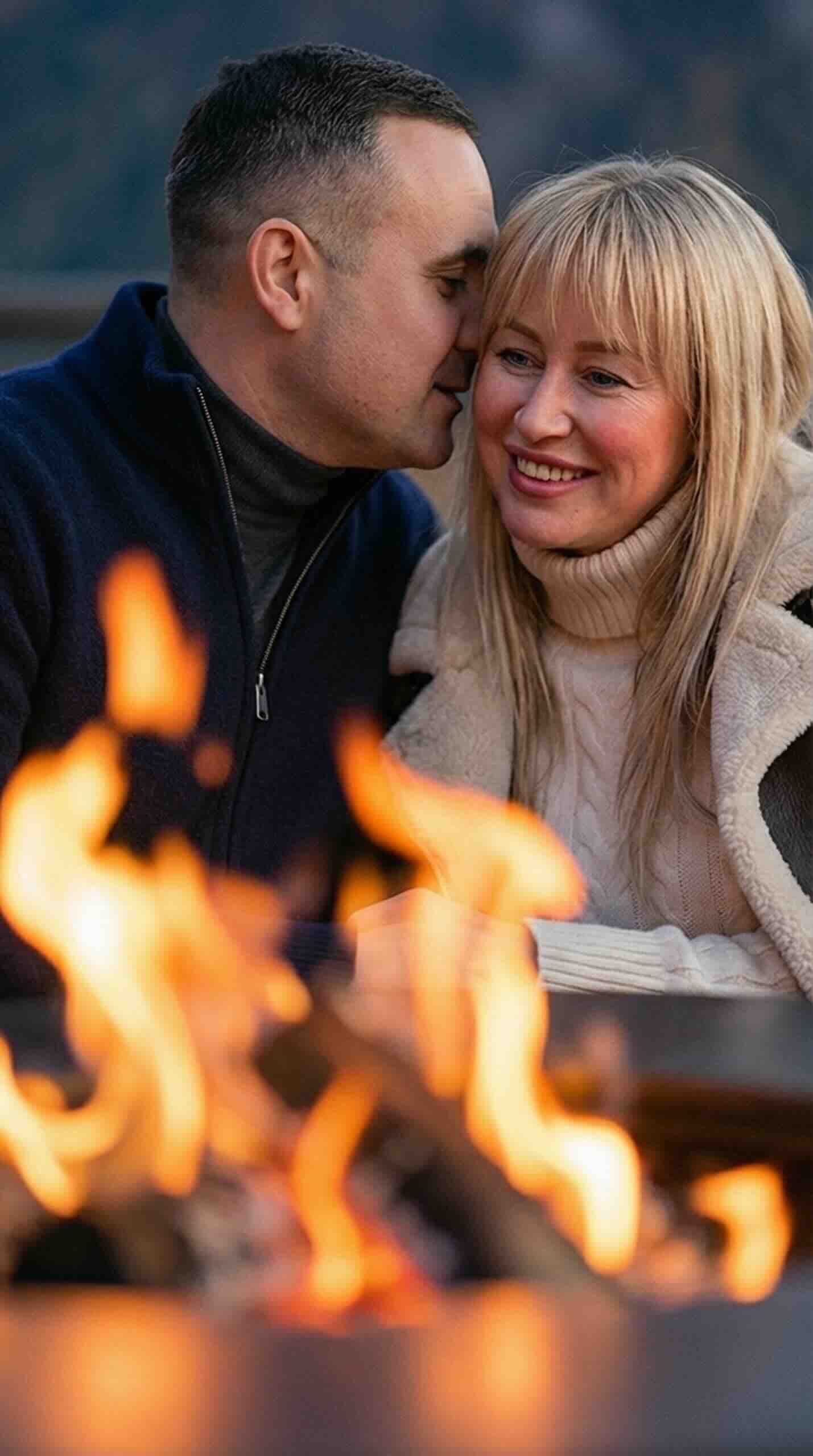 Winter couple photoshoot: beautiful couple sitting by the fireplace, high likeness.